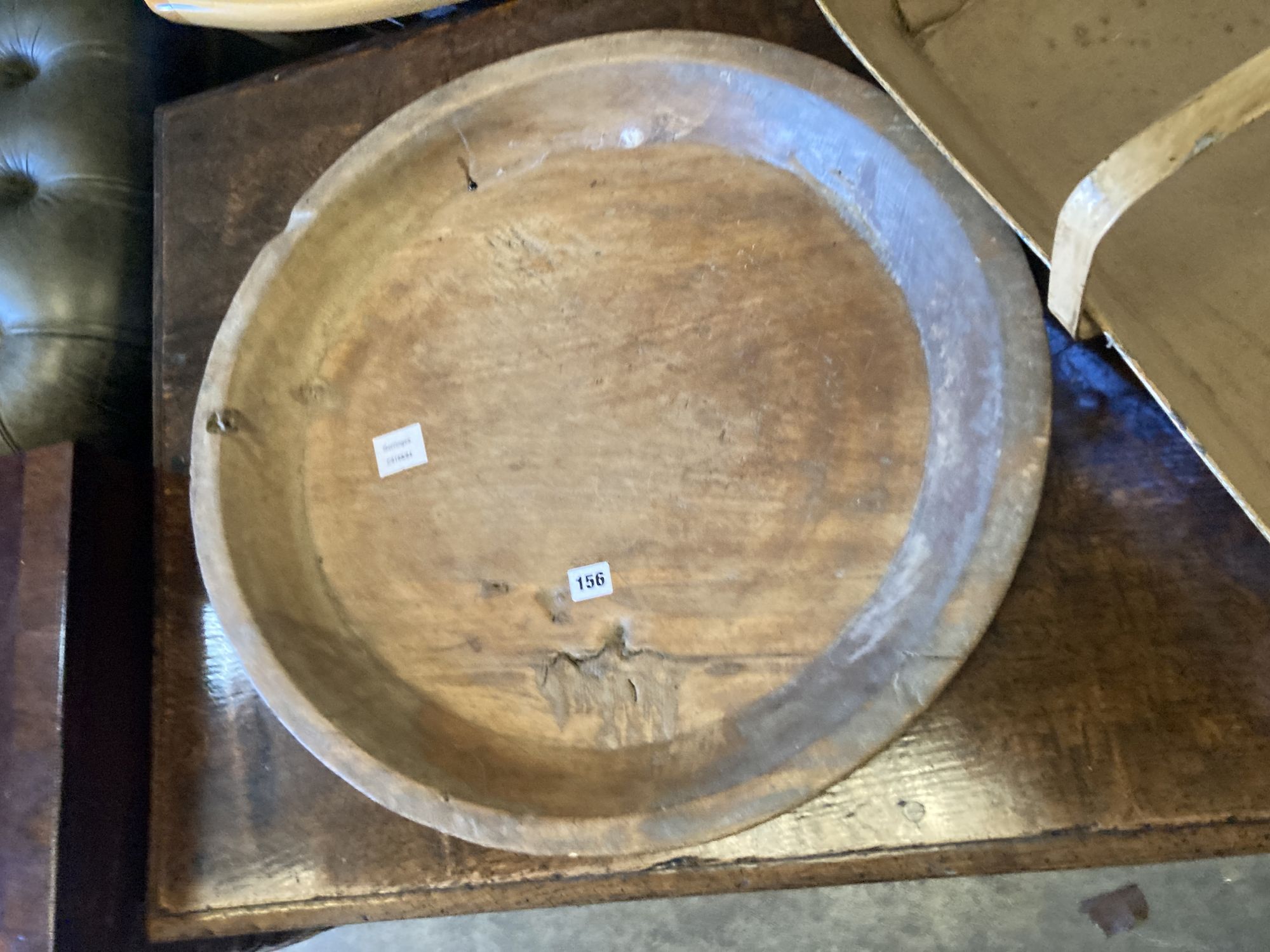 A circular treen shallow bowl and a painted toleware trug, width 69cm, depth 36cm, height 32cm